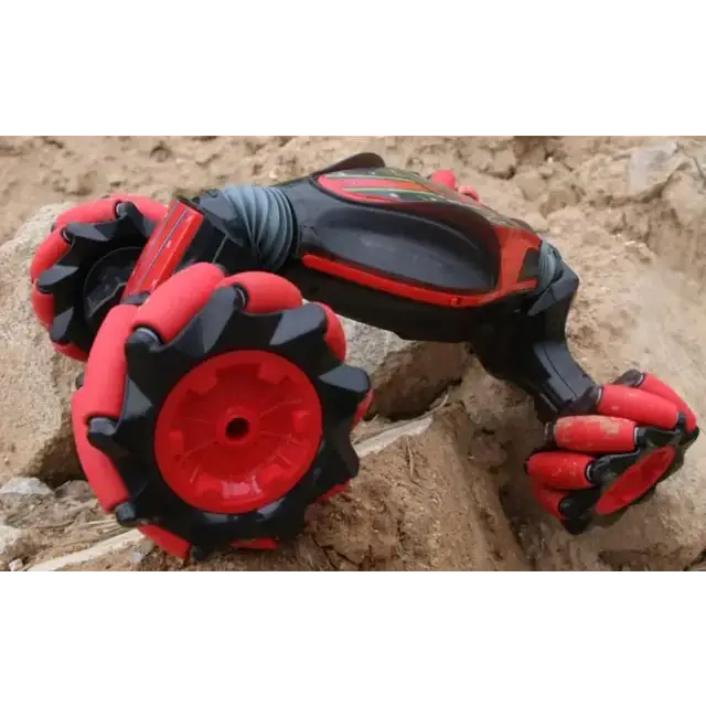 Red and black robotic arm toy car with articulated joints and chunky, textured wheels.