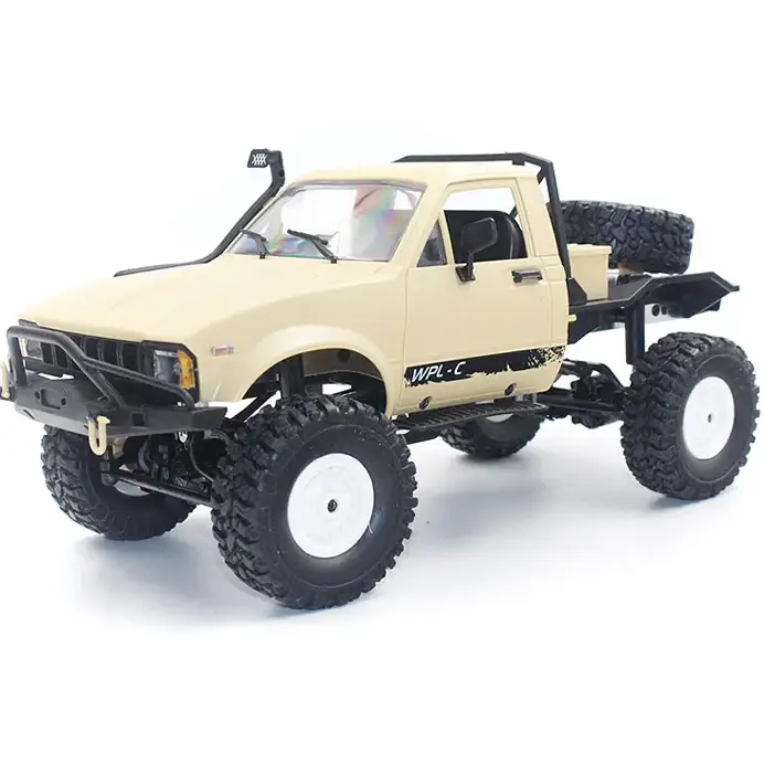 Beige off-road pickup truck model with black accents and white-rimmed tires.