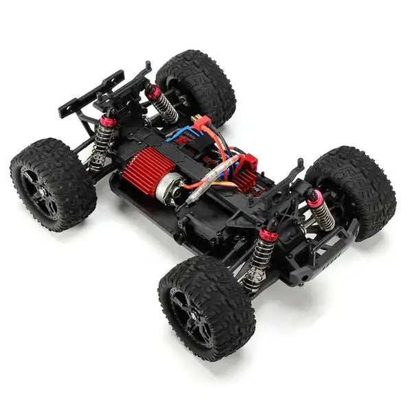 Black and red remote-controlled off-road truck with rugged tires, exposed suspension components, and a detailed chassis.