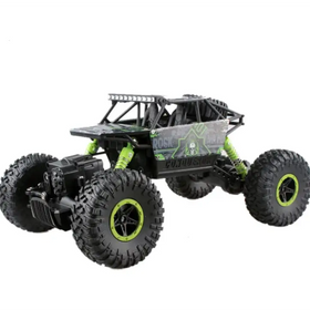 Black and neon green remote-controlled rock crawler with rugged off-road tires, a skeletal logo decal on the side, and visible suspension springs.