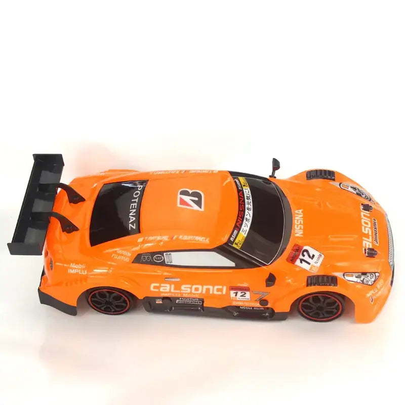 Vibrant orange die-cast race car model with black accents and detailed sponsor decals.