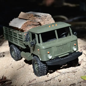 Olive green remote-controlled military truck with rugged tires and a detailed grille.