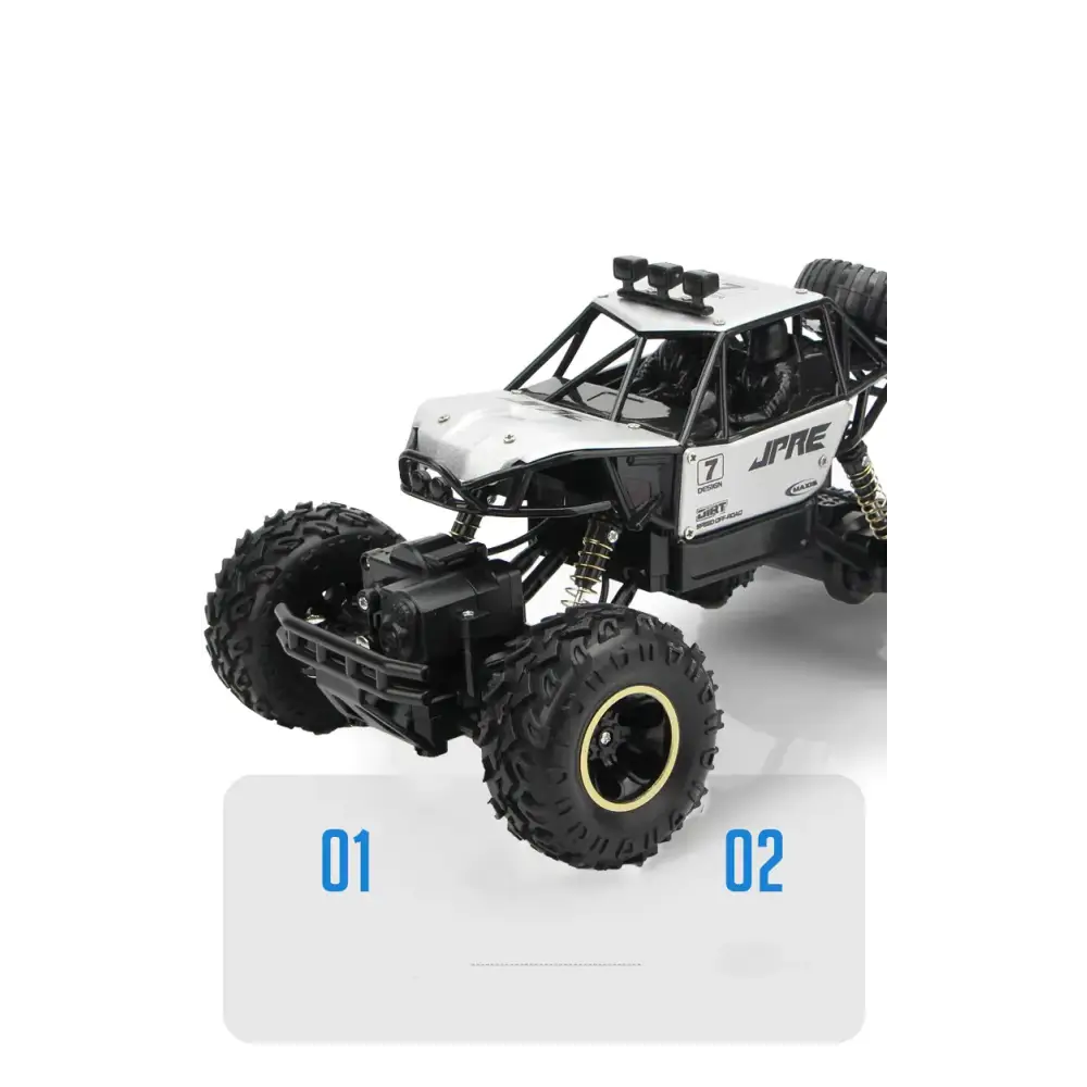 Black and white jpre remote-controlled off-road truck with rugged tires and detailed suspension.