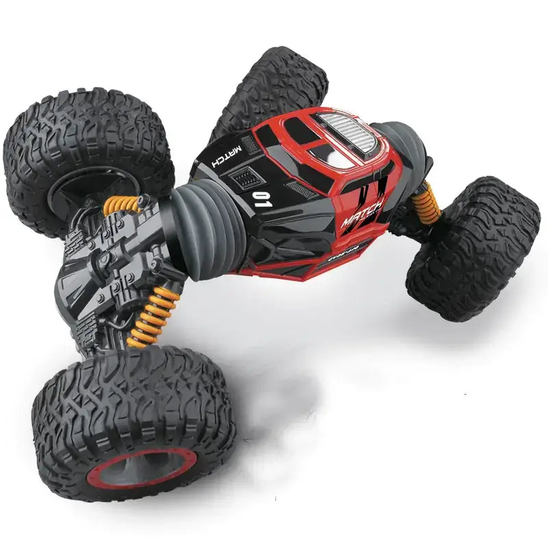 Red and black remote-controlled off-road monster truck with rugged tires, yellow suspension springs, and a detailed chassis.