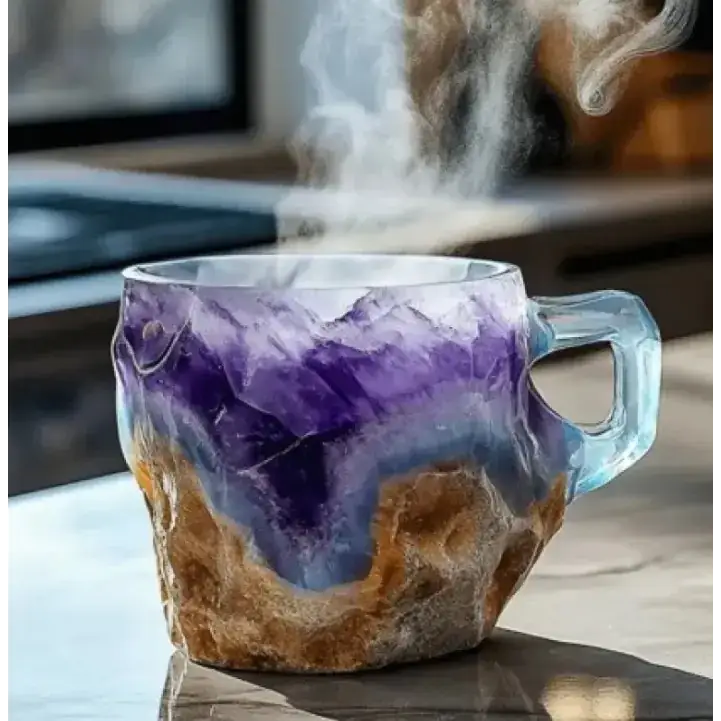 A steaming, translucent glass mug with a rugged, layered design featuring deep purple amethyst and earthy brown stone-like textures.