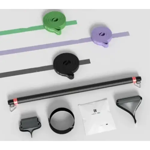 The image displays a set of resistance bands and accessories, including green, purple, black elastic bands with textured surfaces, alongside metal attachments like handles and loops.
