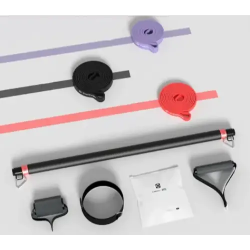 Black resistance training bar with red and purple elastic bands, black adjustable straps, and a white packet of accessories