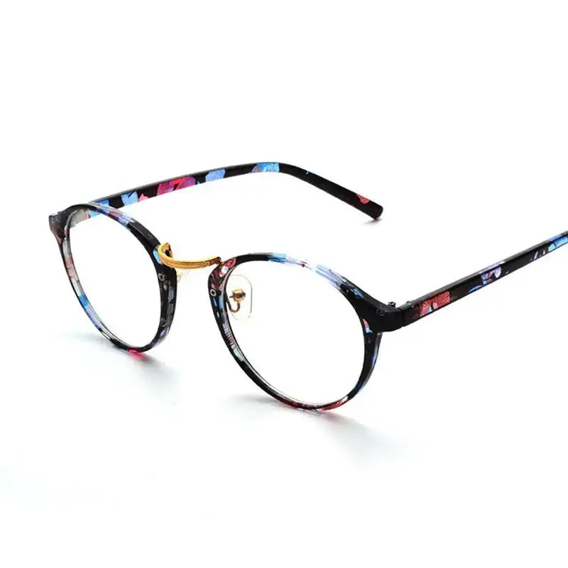 Round-framed glasses with a black base and vibrant floral pattern in blue, pink, and red hues, accented by gold-colored metal details.