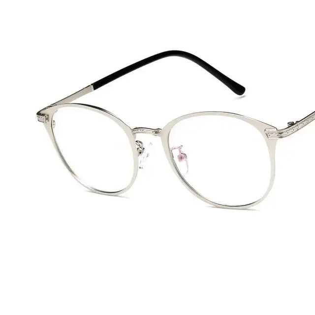 Silver-framed round eyeglasses with black temple tips and subtle engraved detailing.