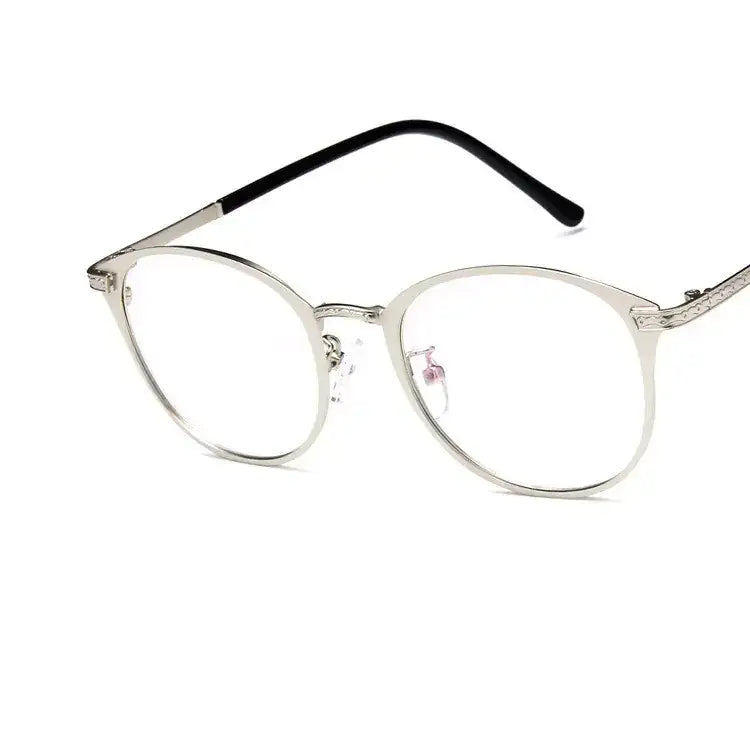 Silver-framed round eyeglasses with black temple tips and subtle engraved detailing.