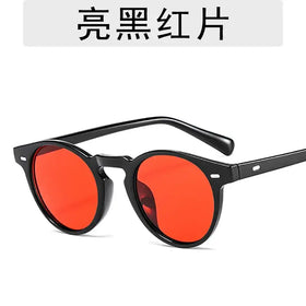 Black-framed round sunglasses with bright red lenses.