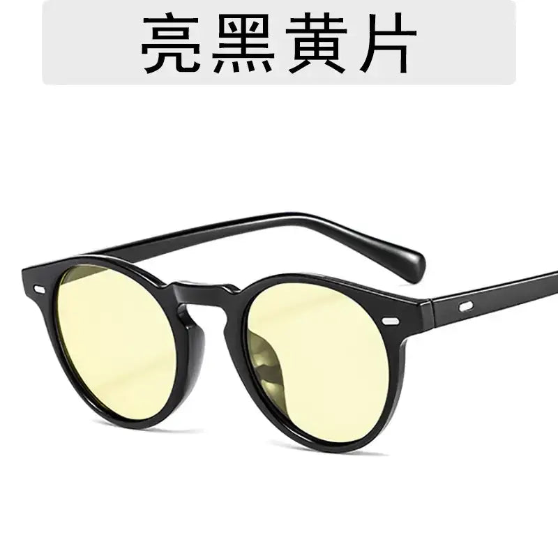 Black-framed round sunglasses with bright yellow lenses.