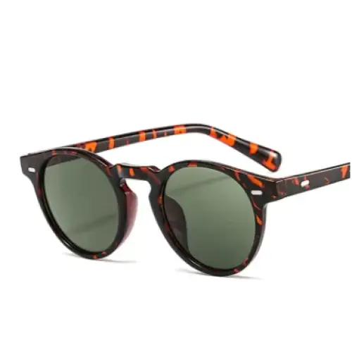 Tortoiseshell-patterned round sunglasses with green lenses.