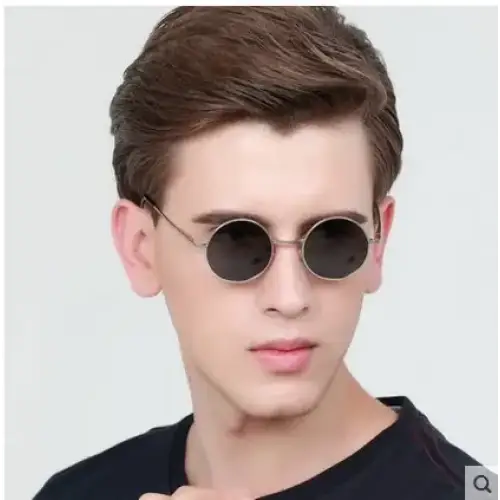 Round black lenses with thin metallic frames, worn by a man.