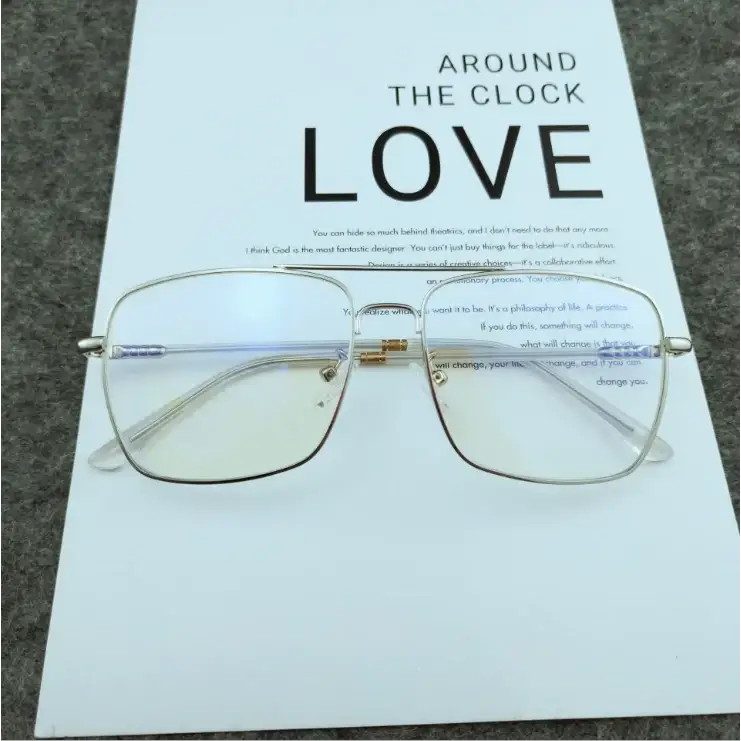 Silver-framed rectangular glasses with gold-tone accents and clear lenses.