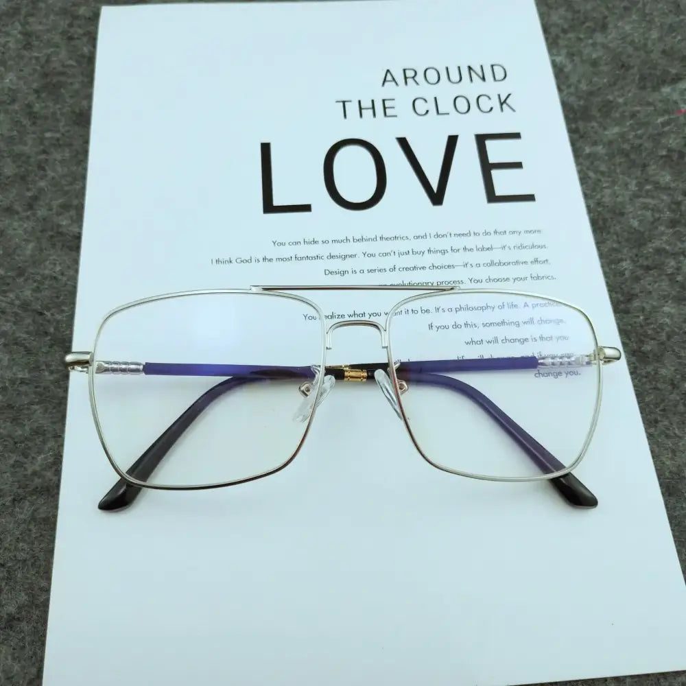 Silver-framed rectangular glasses with purple and black temple arms, featuring a gold-colored hinge.