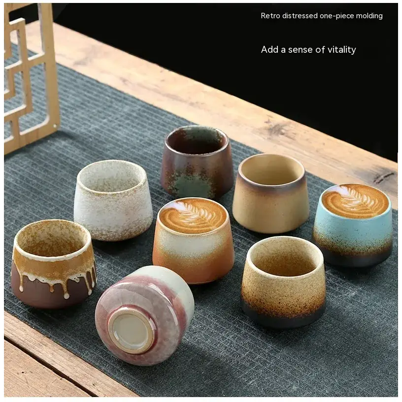 Retro distressed ceramic tea cups in earthy tones with hand-painted glazes and rustic, one-piece molding.