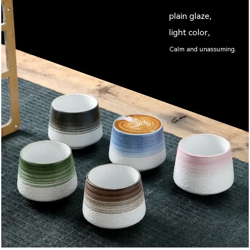 Set of five ceramic coffee cups with subtle gradient glazes in soft pastel tones.