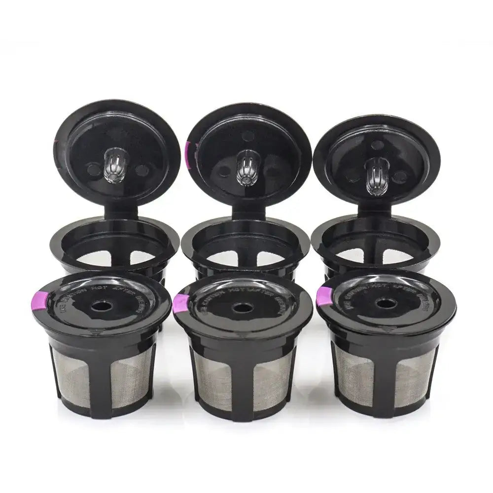 Black plastic and metal coffee filter pods with a pink accent on the lid.