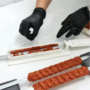 White plastic skewer meat filler tool with red ground meat inside