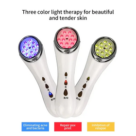 Three color light therapy facial device with white sleek body and led heads in blue, pink, and green.