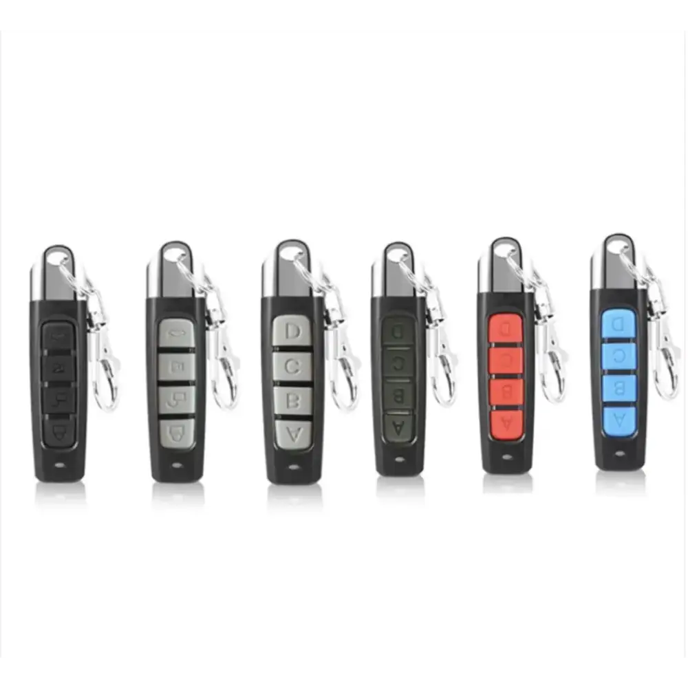 Black and silver garage door remote controls with keychains, featuring buttons labeled a through d in various color schemes.