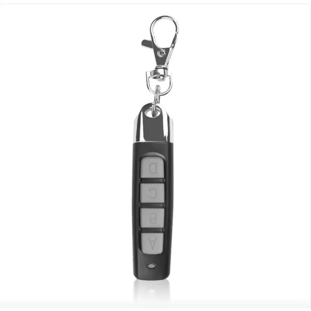 Black remote control with silver buttons labeled a through d and a chrome keychain attachment.