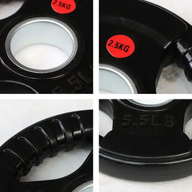 Black 2.5kg weight plate with a silver center and textured grip surface, marked ’5.5lb’ on its side.
