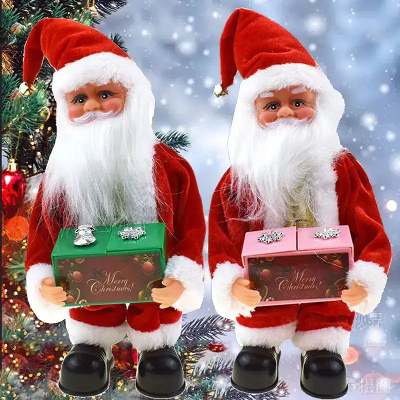 Two festive, plush santa claus figurines in red velvet suits with white fur trim and black boots, each holding a decorated gift box—one green, one pink—with ’merry christmas!’ printed on them.