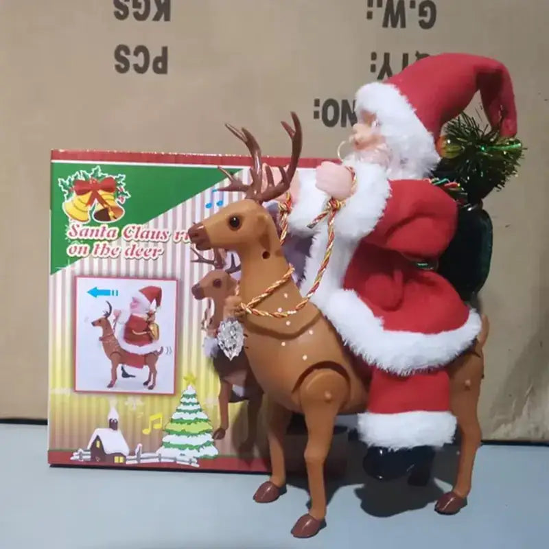 Red and white plush santa claus figure riding a brown plastic reindeer with antlers, holding a small green christmas tree in his backpack.