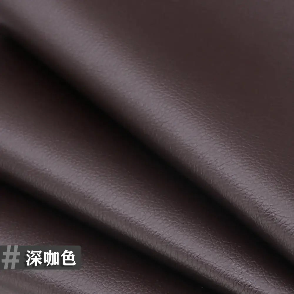 Dark brown faux leather material with a textured, pebbled surface.
