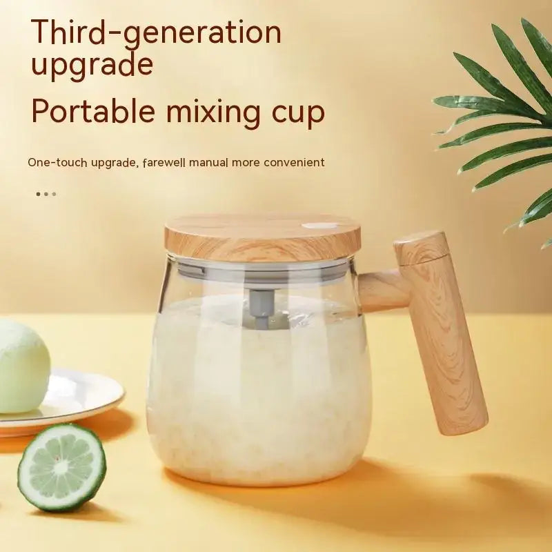 Clear glass portable mixing cup with a wooden lid and handle, featuring an integrated blending mechanism.