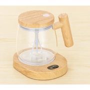 Wooden base electric immersion blender with clear glass jar and bamboo handle.
