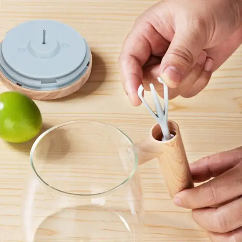 Wooden-handled citrus juicer with a light gray plastic reamer and matching lid