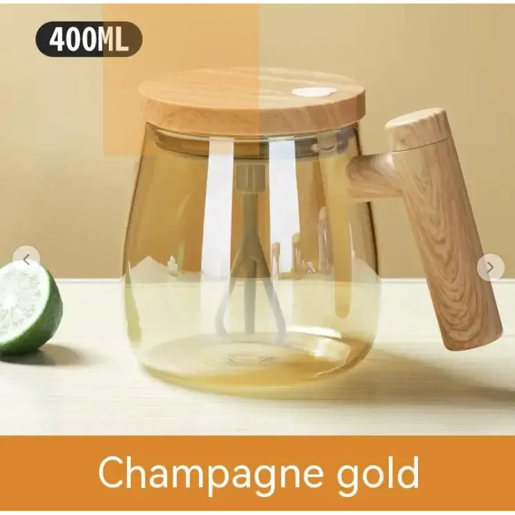 Champagne gold glass pitcher with wooden lid and handle, featuring a built-in whisk for mixing.