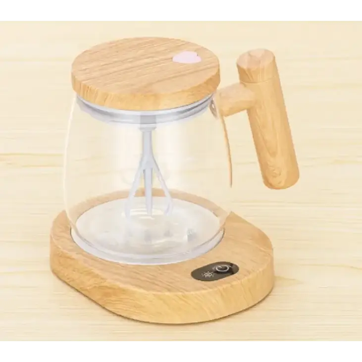 Wooden-handled electric hand mixer with clear glass jar and bamboo lid, resting on a matching wooden base