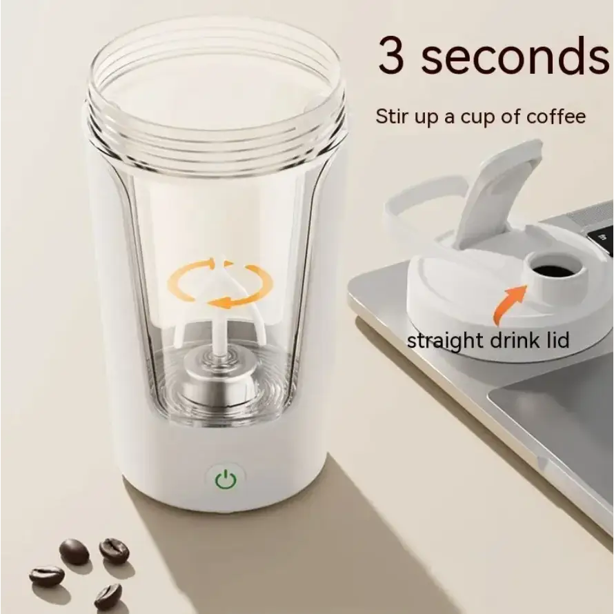 White electric coffee maker with clear glass body and a removable lid featuring an orange arrow graphic.