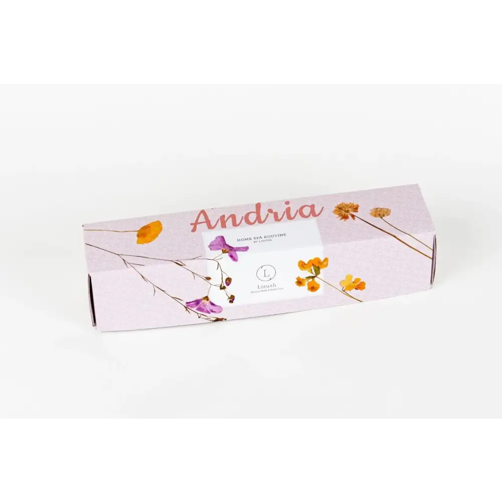 A lavender-colored rectangular box with a floral design featuring purple and orange flowers, adorned with the brand name ’lush’ on its label.