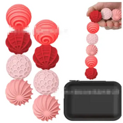 Set of red and pink silicone laundry balls with textured, spiral and honeycomb designs.