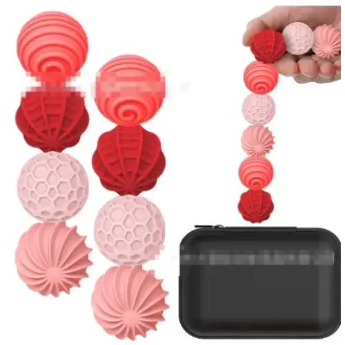 Set of red and pink silicone laundry balls with textured, spiral and honeycomb designs.