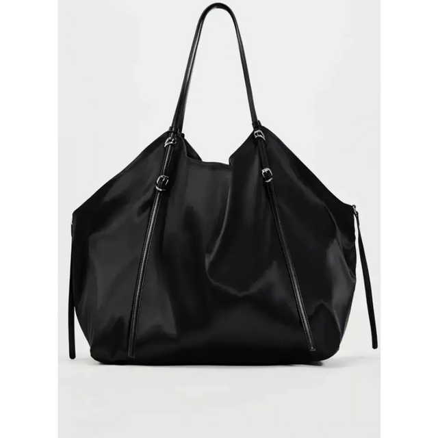 Black nylon tote bag with sleek, minimalist design and matching black leather handles.