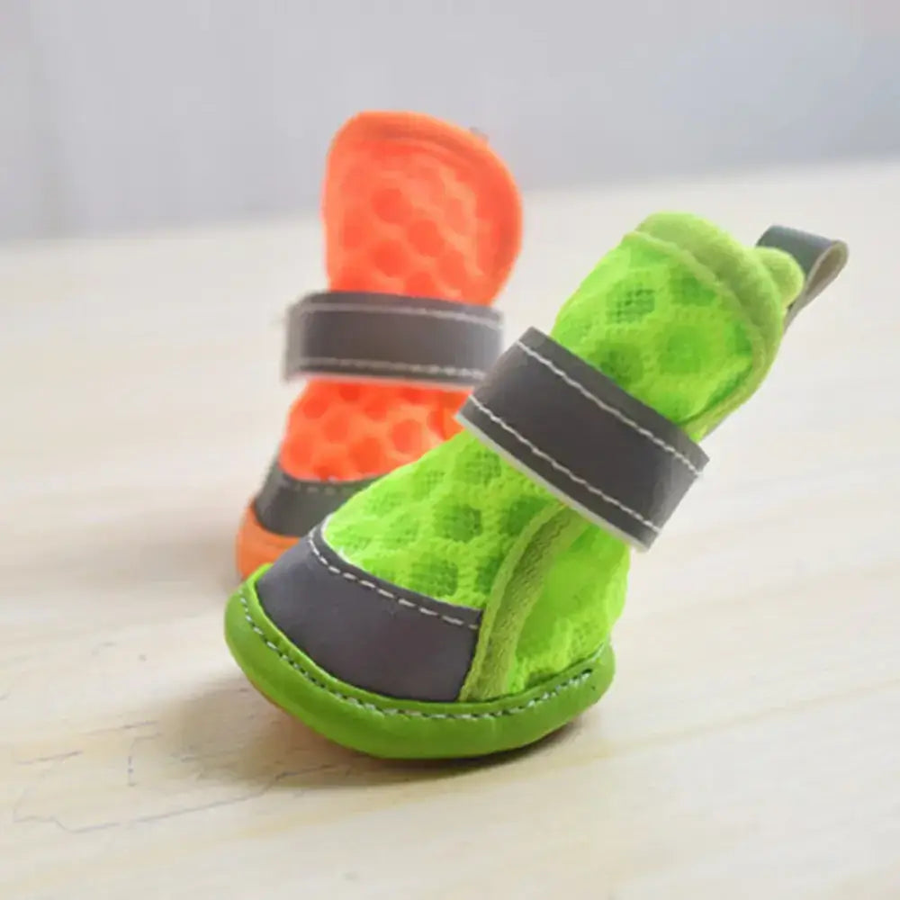 Bright green and orange mesh pet booties with gray straps.