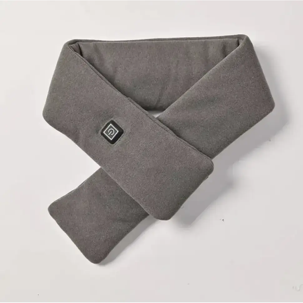 A gray, soft-textured heated neck warmer with a small black power button on the front.