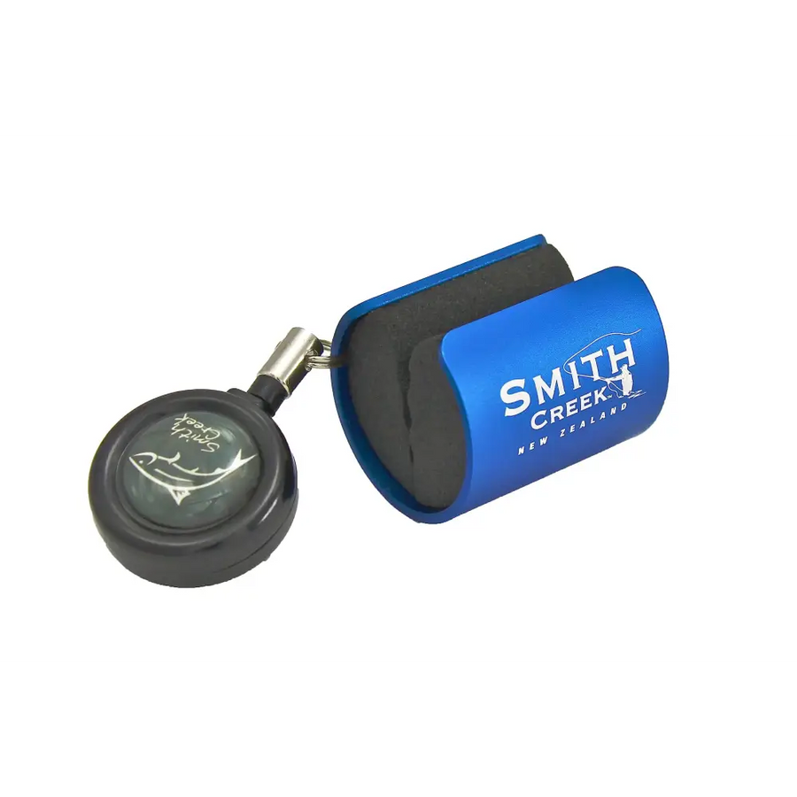 Blue smith creek new zealand retractable fishing lure holder with black foam insert and a matching black circular reel cap featuring a fish design.