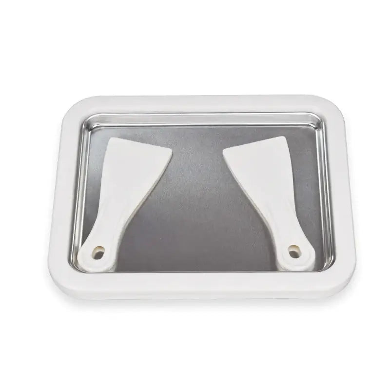 White rectangular tray with two white spatulas resting inside