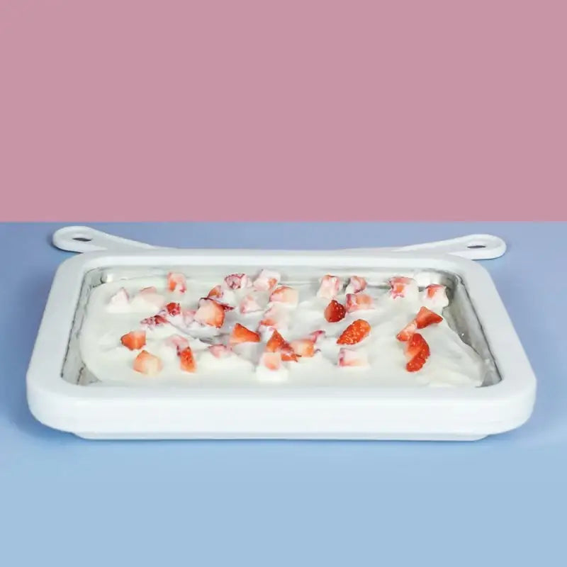 White silicone ice cream maker with strawberry pieces on top