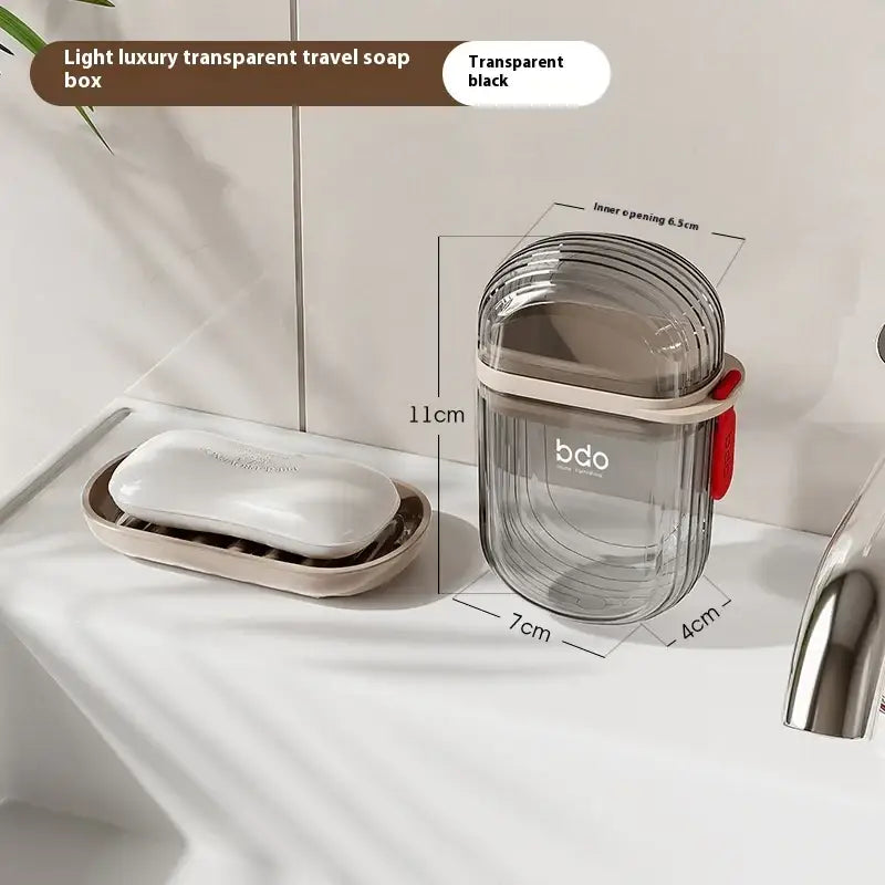 Transparent black travel soap box with ribbed design and a red pull-tab.