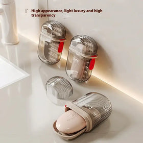 Transparent, ribbed plastic soap dish with a beige silicone insert and red accent clip.