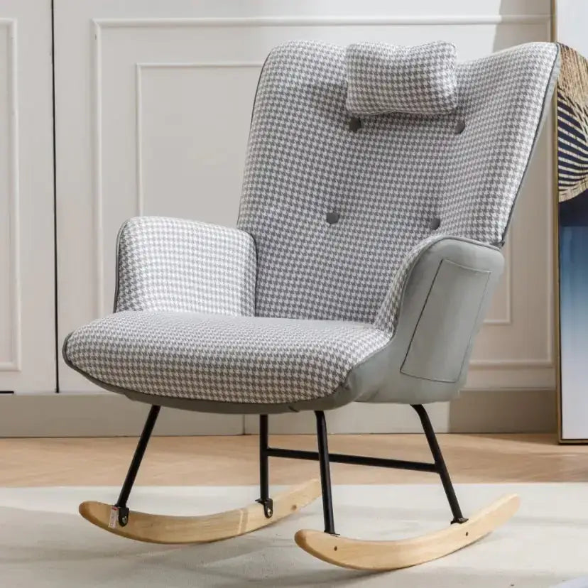 A cozy gray and white houndstooth-patterned rocking chair with a matching cushioned headrest, upholstered in fabric over a black metal frame with light wooden rockers.