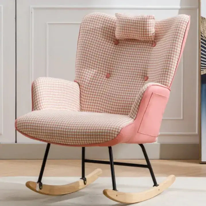 Pink and beige houndstooth patterned rocking chair with a matching cushion, upholstered in fabric over pink leather accents.